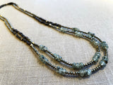 top view of gemstone bead necklace comprising green prehnite, golden pyrite and dark bronze. 