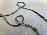closeup view of gemstone bead necklace comprising green prehnite, golden pyrite and dark bronze. 