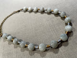 top view of gemstone bead necklace comprising white siberian moonstone and gold and silver hematite. 