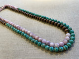 top view of gemstone bead necklace comprising light purple kuznite, green amazonite and brown exotic wood. 