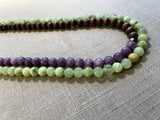 side view of gemstone bead necklace comprising purple lepidolite, green calcite and brown exotic wood. 