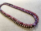 top view of gemstone bead necklace comprising purple lepidolite, pink strawberry quartz and brown exotic wood. 