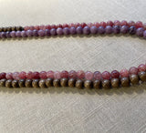 side view of gemstone bead necklace comprising purple lepidolite, pink strawberry quartz and brown exotic wood. 