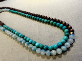 top view of gemstone bead necklace comprising blue azurite, turquoise and brown exotic wood. 
