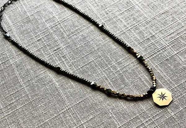 top view of antique victorian pendant hung on metallic bead choker