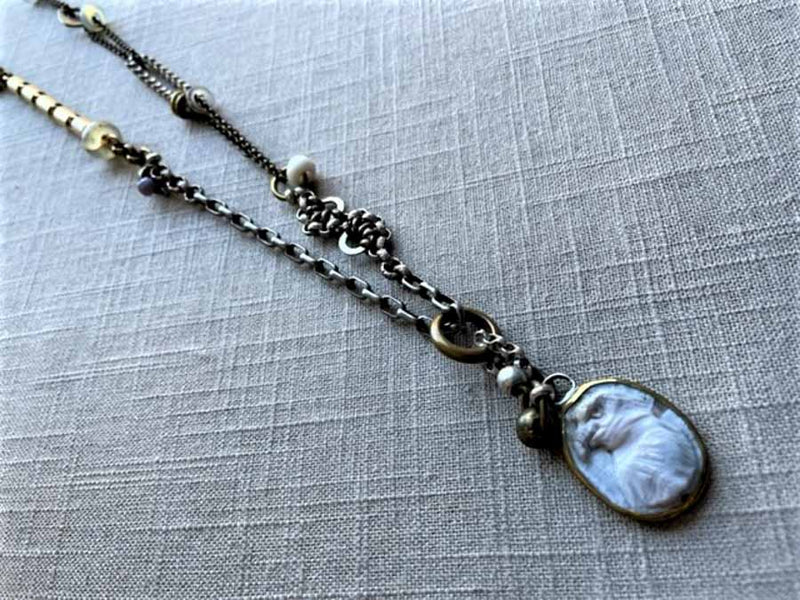 top view of antique carved eagle cameo pendant on chain mix